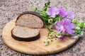 Loaf of rye bread with caraway seeds and wild flowers
