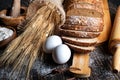 Loaf of rye bread, ears of wheat, eggs and a bowl of flour. Close-up Royalty Free Stock Photo
