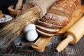 Loaf of rye bread, ears of wheat, eggs and a bowl of flour. Close-up Royalty Free Stock Photo