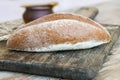 A loaf of rye bread oval shape on a wooden Board vintage, rustic style, homemade cakes