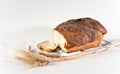 Loaf and slice of wheat bread with wheatears Royalty Free Stock Photo