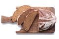 Loaf and slices of rye bread on a cutting boards isolate