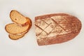 Loaf and slices of wheat bread on white background. Royalty Free Stock Photo