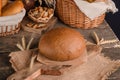 Loaf of traditional round rye bread on wooden background