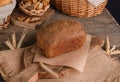 Loaf of traditional rye bread on wooden background
