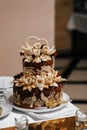 Loaf. Wedding cake. Ukrainian traditional loaf in the form of a cake on the wedding table decorated with flowers and rings in