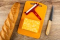 Loaf of bread, piece of marble cheese, cheese cutter on cutting board, knife on wooden tableÃÅ½ Top view Royalty Free Stock Photo