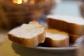 Loaf of white bread, sliced in a plate on a table on a blurry brown background Royalty Free Stock Photo