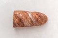 Loaf of whole grain bread on a white background. Baked waste concept. Close-up, top view Royalty Free Stock Photo