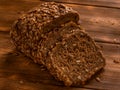 Loaf of whole grain bread on wooden background Royalty Free Stock Photo
