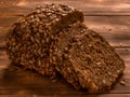 Loaf of whole grain bread on wooden background Royalty Free Stock Photo