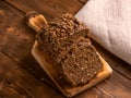 Loaf of whole grain bread on wooden background Royalty Free Stock Photo