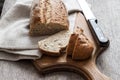 Loaf of whole wheat bread with slices on wooden board Royalty Free Stock Photo