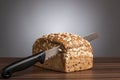 Loaf of wholemeal bread with knife on table