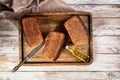 Loafs of rye bread. Fresh homemade bread made from whole grain rye flour. Delicious traditional pastries on a wooden tray Royalty Free Stock Photo