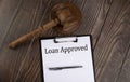 LOAN APPROVED text on the paper with gavel on wooden background Royalty Free Stock Photo