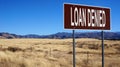 Loan denied brown road sign
