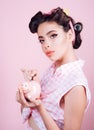 Loan. Money. Housewife. pin up woman with trendy makeup. pinup girl with fashion hair. retro woman with moneybox. pretty Royalty Free Stock Photo