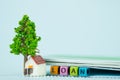 LOAN text and small model house and little tree with notebook, s Royalty Free Stock Photo