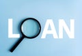 Loan word created with magnifying glass on blue background