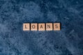 `Loans` spelled out in wooden letter tiles