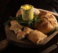 Rosemary butter candle and loaves of crusty breads
