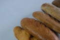 loaves of bread from the bakery on a light background. Variety of loaves, baguettes. Royalty Free Stock Photo