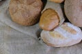 loaves of bread from the bakery in the store. Burlap and straw with pastries. Various loaves, baguettes. Royalty Free Stock Photo