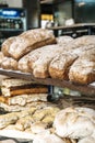 Loaves of bread on the shelves of the shop bakery counter. Fresh, homemade wheat and whole grain breads and pastries. Royalty Free Stock Photo