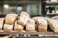 Loaves of bread on the shelves of the shop bakery counter. Fresh, homemade wheat and whole grain breads and pastries. Royalty Free Stock Photo