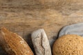 Loaves of different breads on wooden , flat lay. Space for text Royalty Free Stock Photo