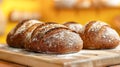 Loaves of whole wheat rye bread on wood board. Yellow background morning sunlight, Bread making concept