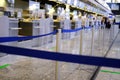 lobby of airport, blue barrier tape separates check-in counters for a flight without people, beautiful modern european airport Royalty Free Stock Photo