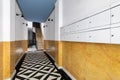 Lobby at entrance of house with long corridor, stairs to second floor, black and white marble mosaic floor, bright