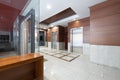 Lobby of an office building with elevators and granite