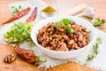 Lobio - the national Georgian dish of beans in a white plate and the ingredients for its preparation