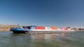 Lobith Netherlands, April 2020, large container vessel on the river rhein near germany with colorful containers on board