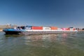 Lobith Netherlands, April 2020, large container vessel on the river rhein near germany with colorful containers on board