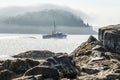 Lobster boat heading out of Bar Harbor Maine as the morning fog Royalty Free Stock Photo