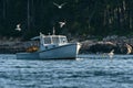 Lobster men hard at work on a beautiful morning in early autumn in South Bristol, Maine, United States Royalty Free Stock Photo