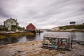 Lobster Cage and houses on Peggy`s Cove on a cloudy day