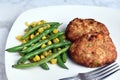 lobster cakes with sauteed green beans and vegetables