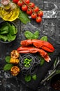 Lobster claw with black pasta and vegetables on the black stone plate. Seafood. Top view. Royalty Free Stock Photo