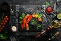 Lobster claw with black pasta and vegetables on the black stone plate. Seafood. Top view. Royalty Free Stock Photo