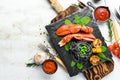 Lobster claw with black pasta and vegetables on the black stone plate. Seafood. Top view. Royalty Free Stock Photo