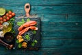 Lobster claw with black pasta and vegetables on the black stone plate. Seafood. Top view. Royalty Free Stock Photo