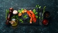 Lobster claw with black pasta and vegetables on the black stone plate. Seafood. Top view. Royalty Free Stock Photo