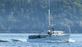 Lobster fishing boat heading out to sea as the fog is lifting over Porcupine Island Royalty Free Stock Photo