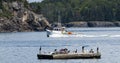 Lobster fishing boat passing porcupine island with bids standing on a float in the foreground