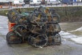 Lobster Pots stacked on the quayside in the popular fishing vill Royalty Free Stock Photo